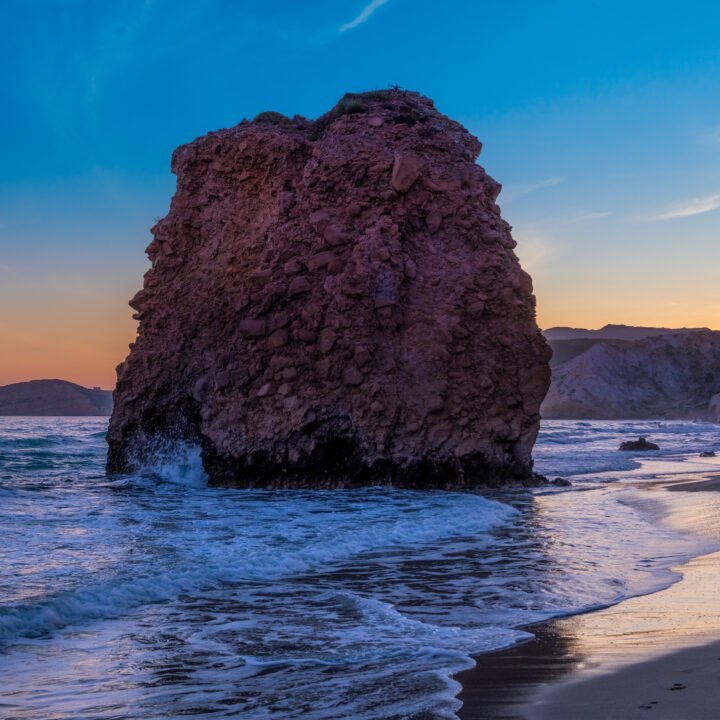 Fyriplaka beach and waves of Aegean sea on sunset, Milos island, Cyclades, Greece